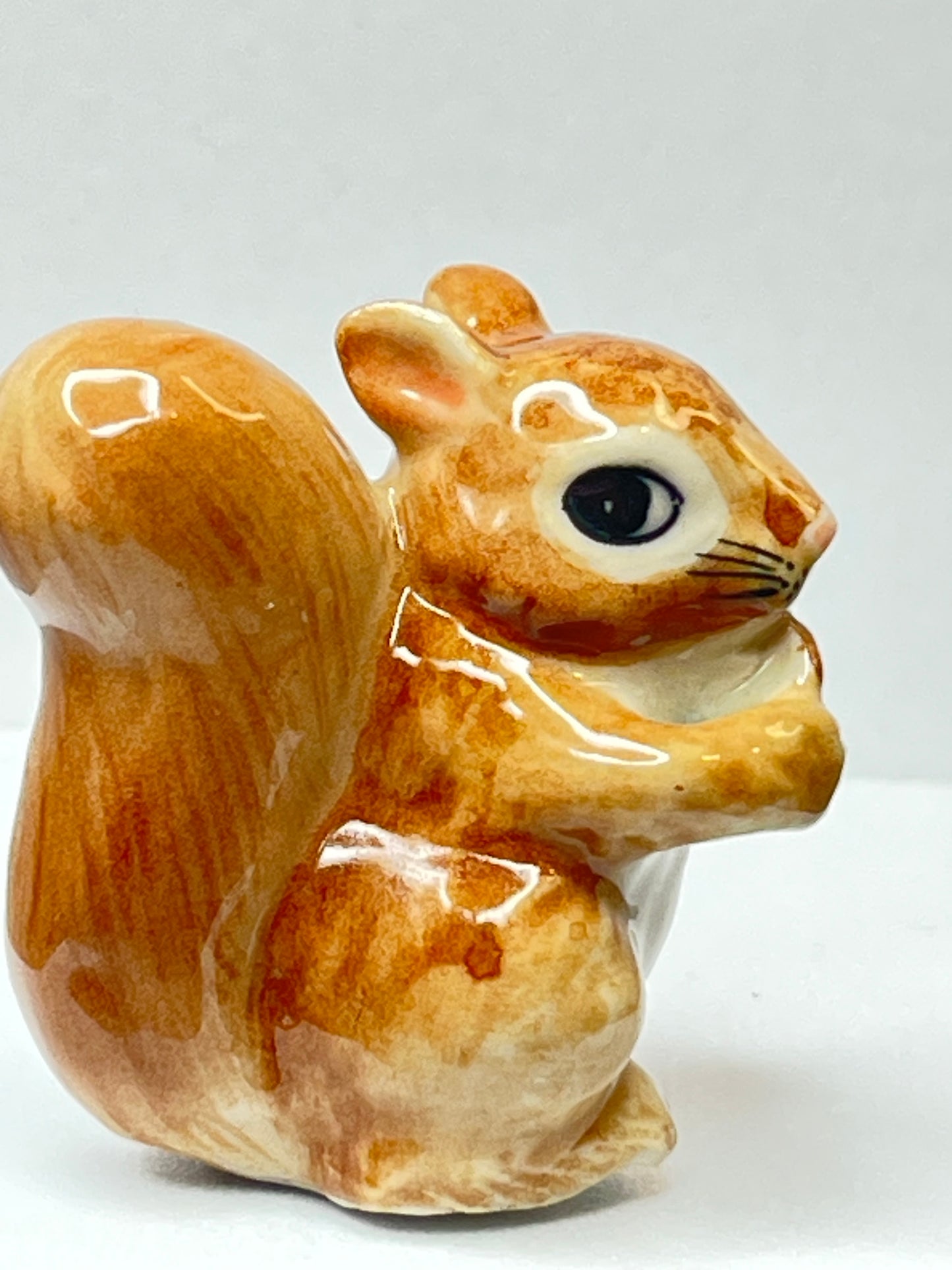 Miniature Porcelain Squirrel Eating Pine Cone Nut Figurine