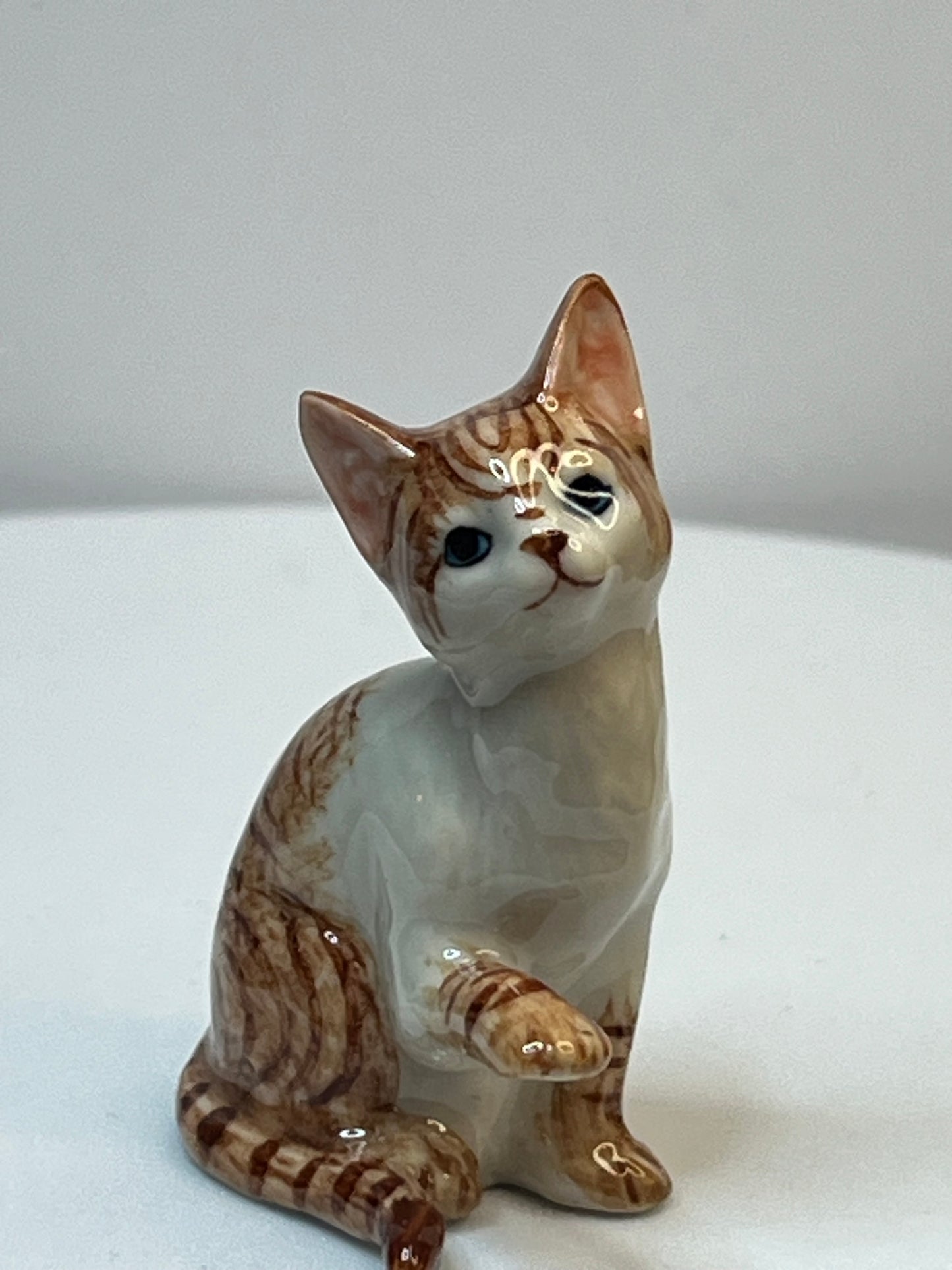 Miniature Porcelain Ginger and White Cat Kitten Figurine With Foot Up