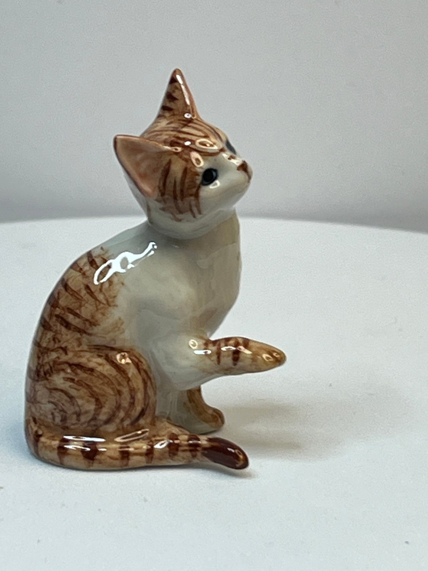 Miniature Porcelain Ginger and White Cat Kitten Figurine With Foot Up