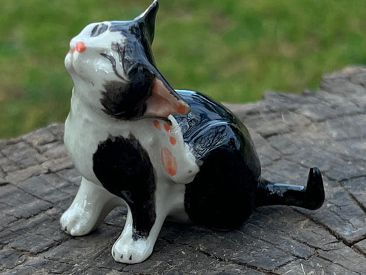 Miniature Porcelain Black and White Cat Scratching Its Ear Figurine
