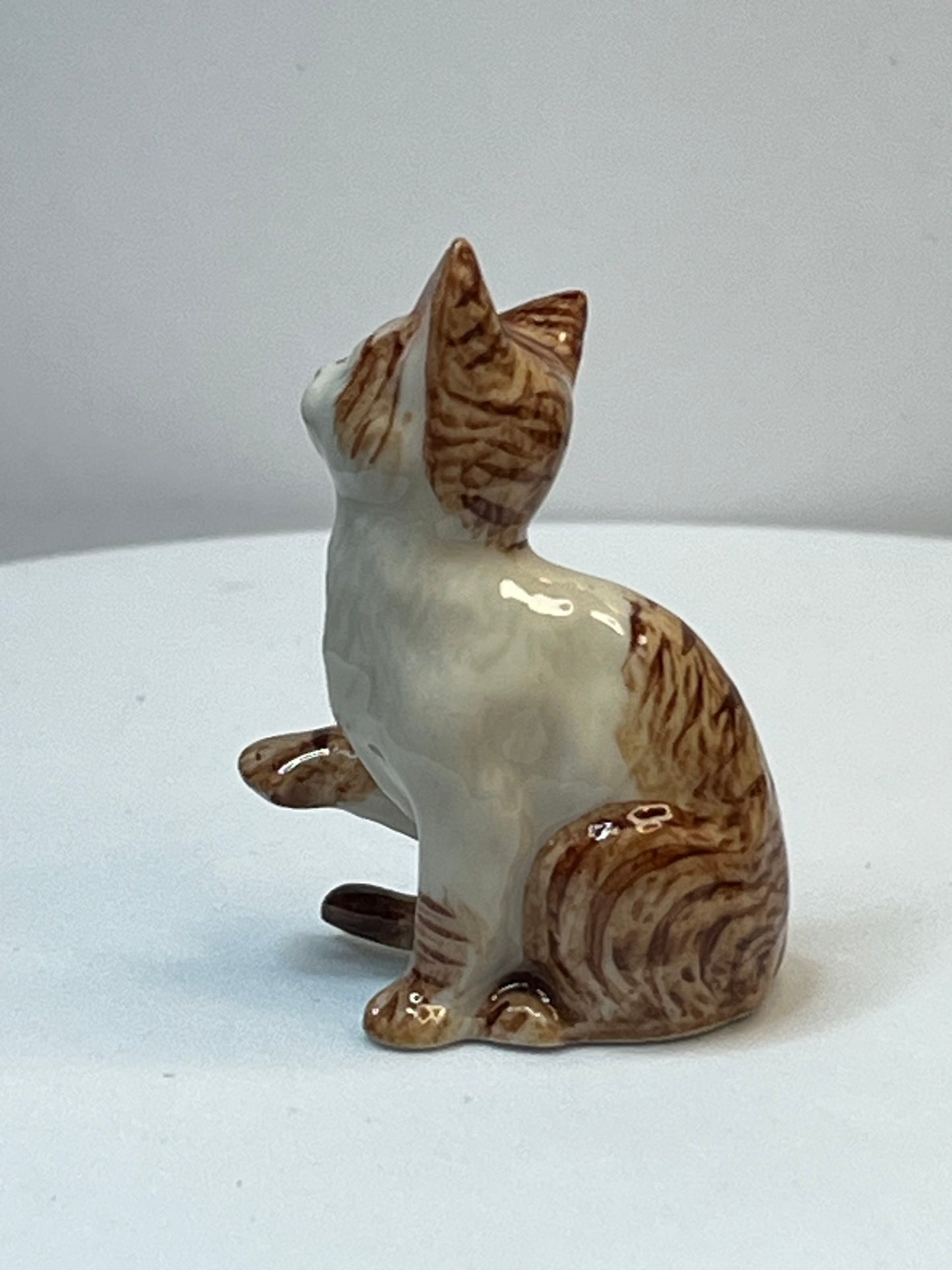 Miniature Porcelain Ginger and White Cat Kitten Figurine With Foot Up