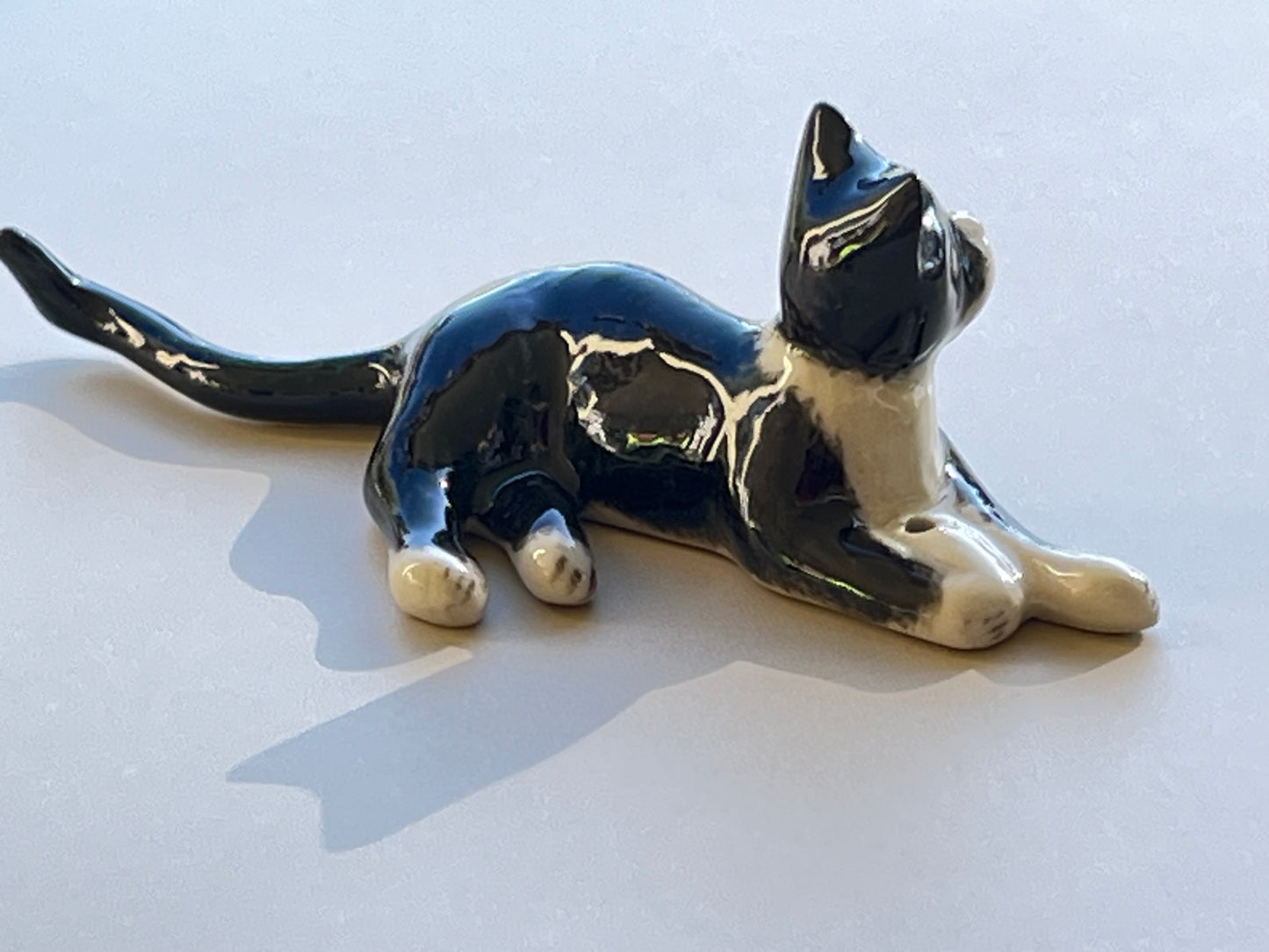 Miniature Porcelain Tuxedo Cat Lying Down
