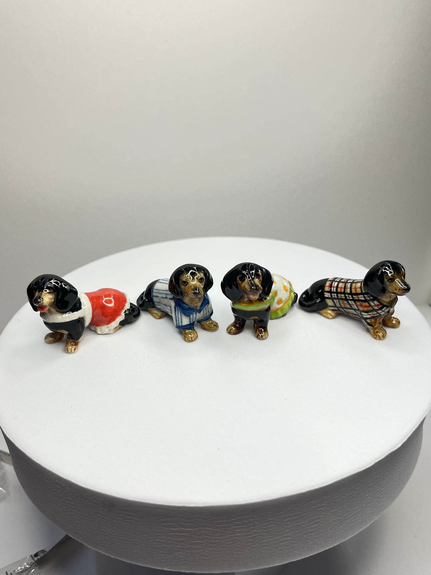 Miniature Porcelain Black Dachshund with Clothes Set of 4 Figurines