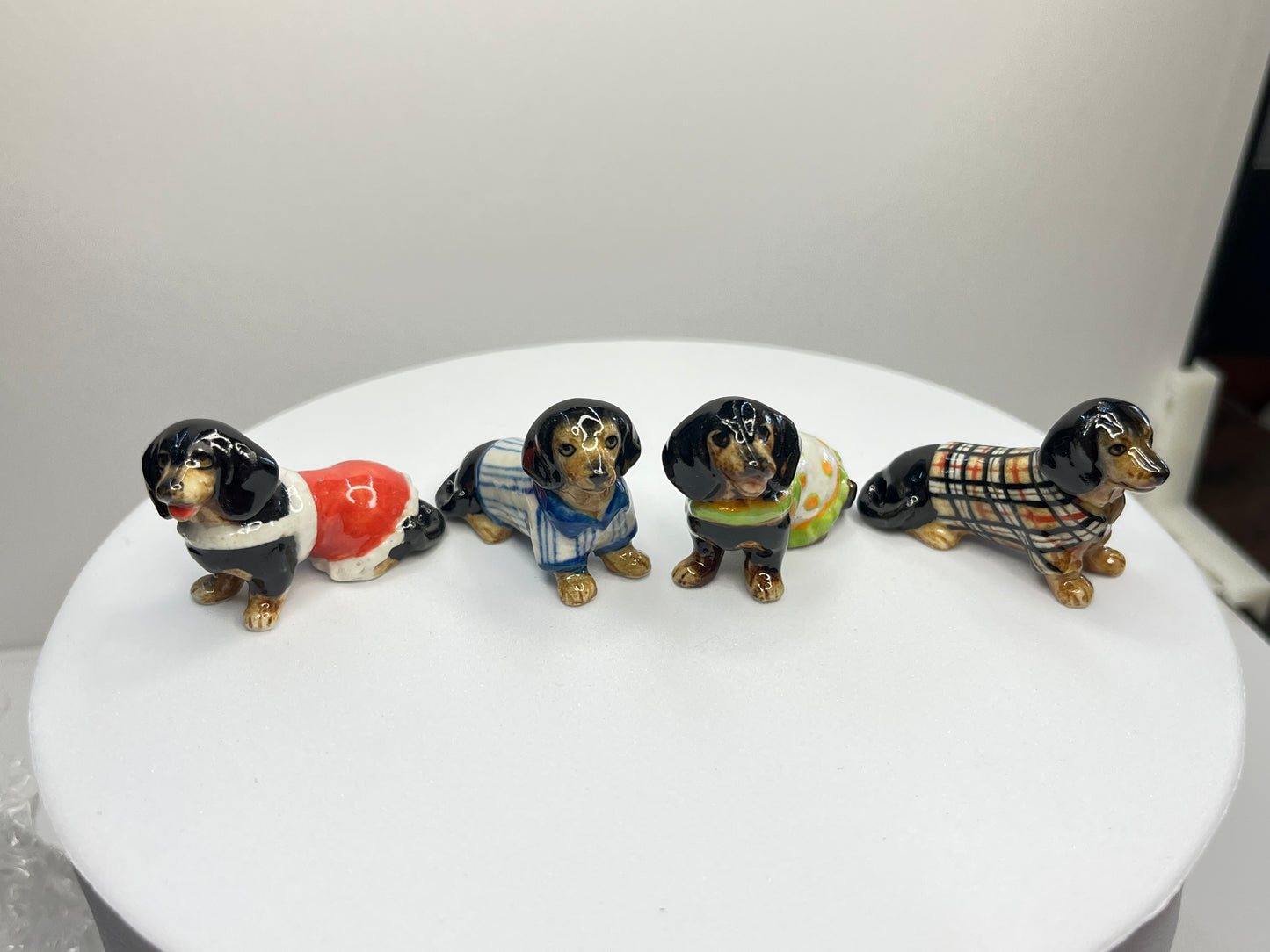 Miniature Porcelain Black Dachshund with Clothes Set of 4 Figurines