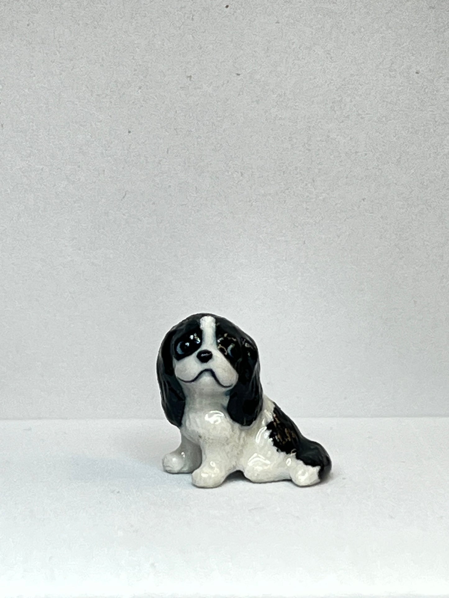 Miniature Porcelain Black and White Springer Spaniel Sitting Figurine