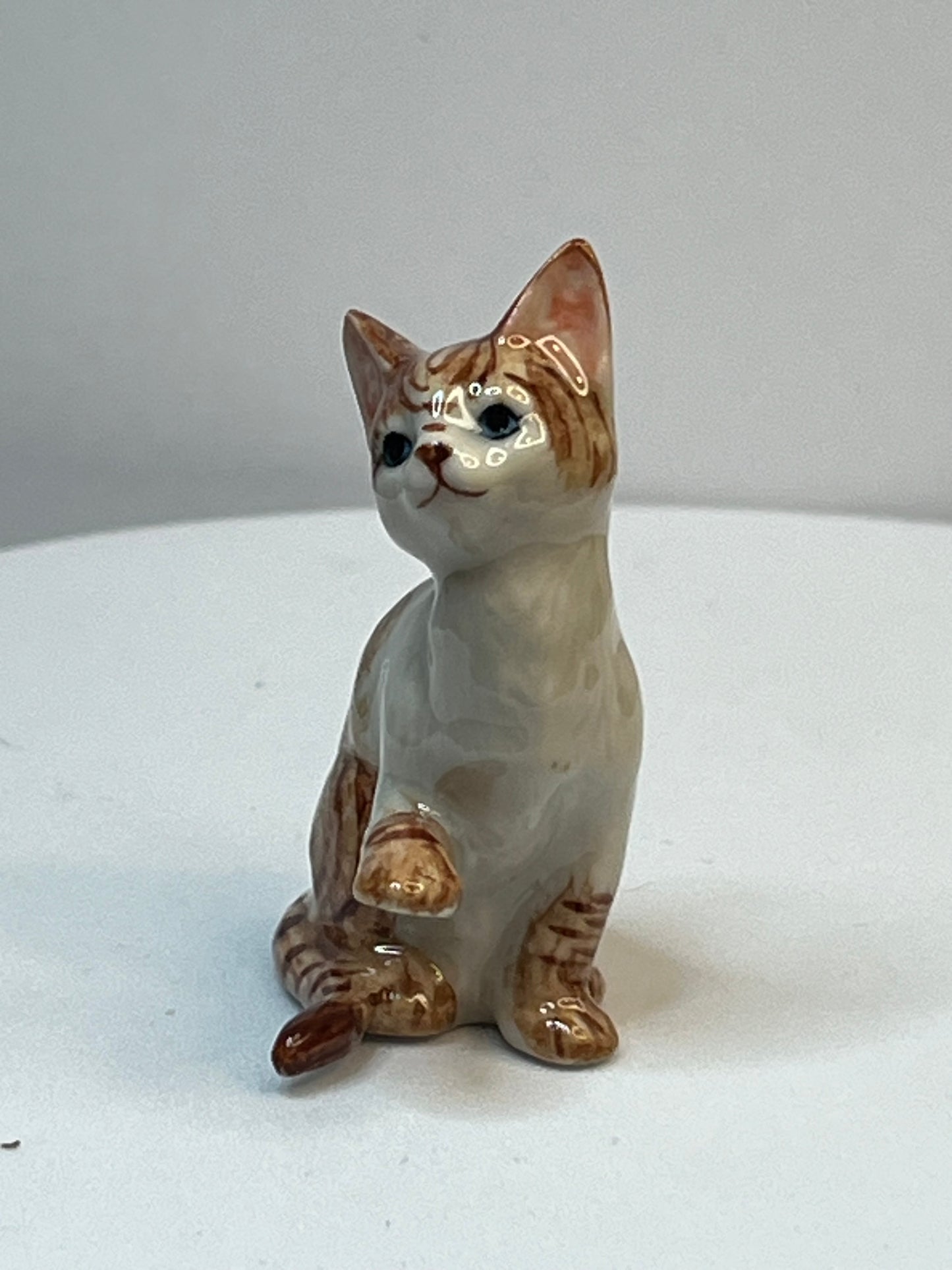 Miniature Porcelain Ginger and White Cat Kitten Figurine With Foot Up