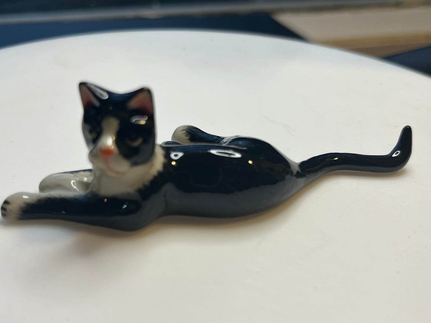 Miniature Porcelain Tuxedo Cat Lying Down