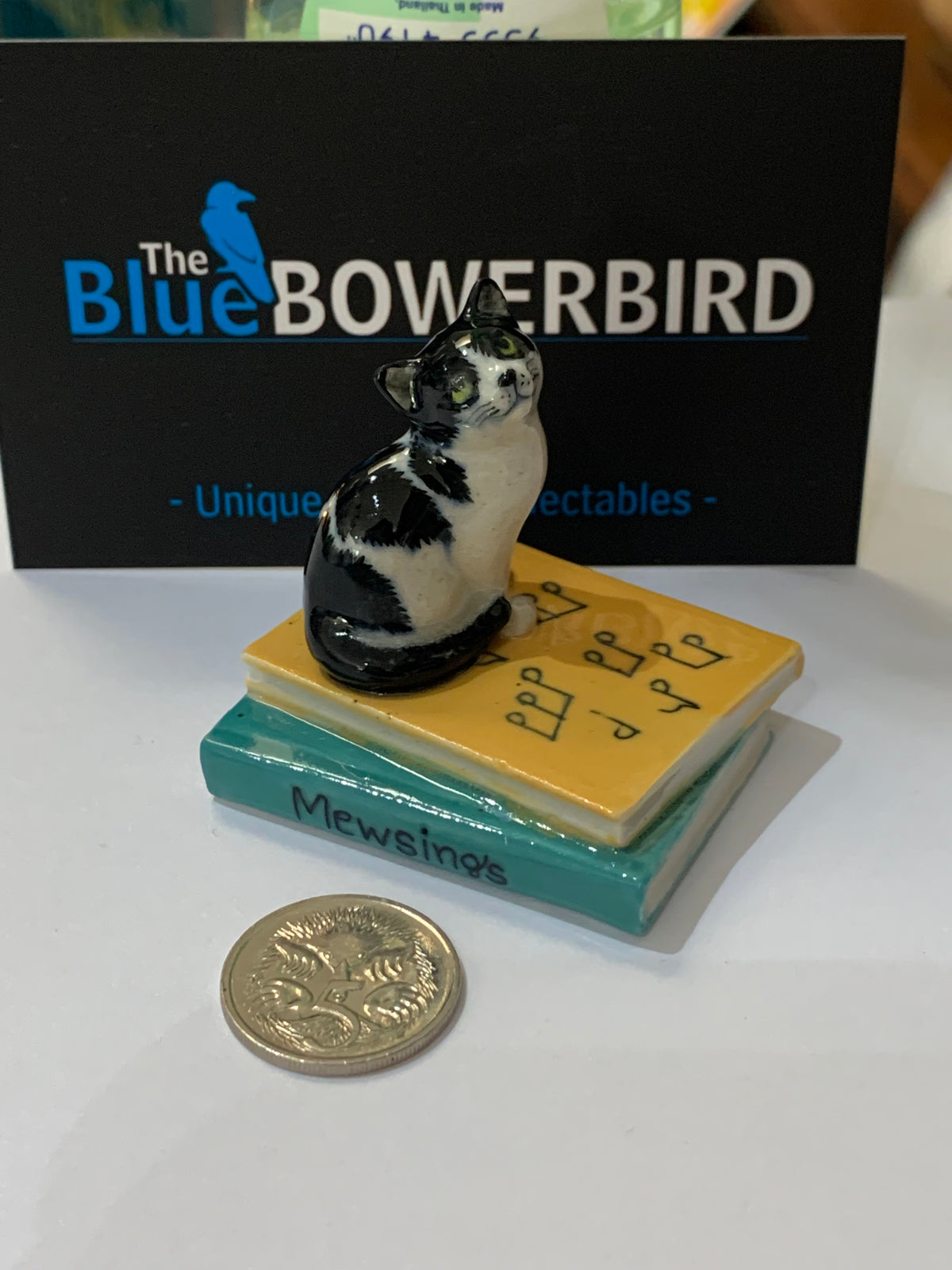 Miniature Porcelain Cat Sitting on Musical Book