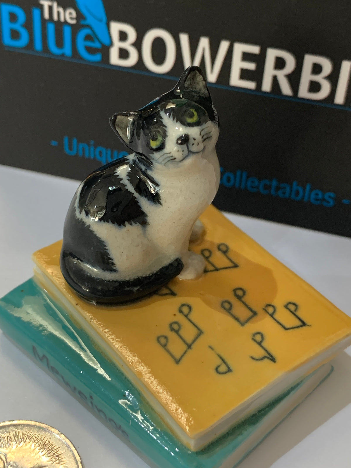 Miniature Porcelain Cat Sitting on Musical Book